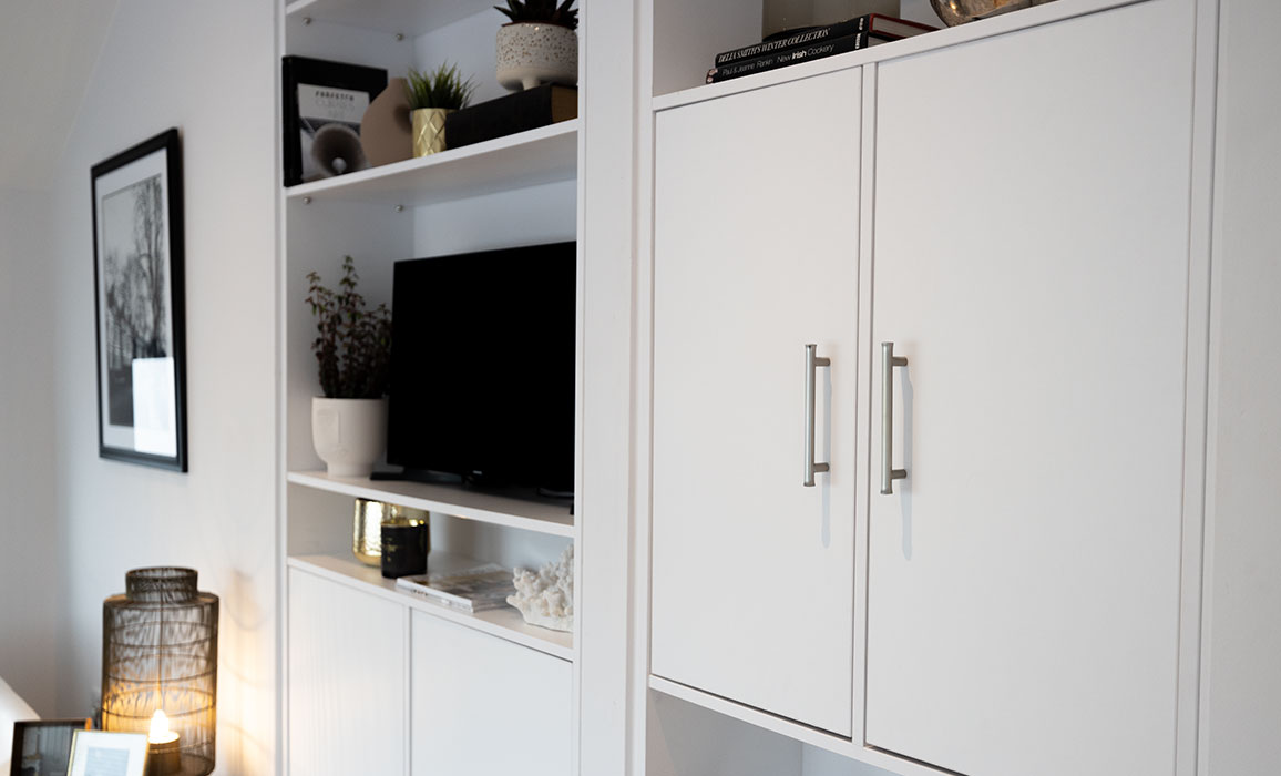 white fitted living room shelves