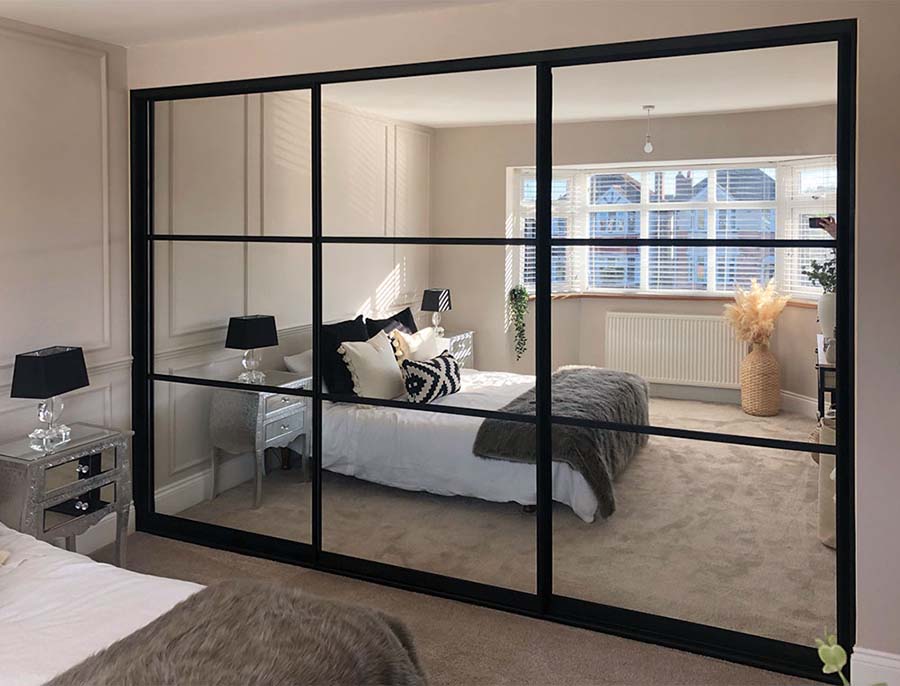 black framed sliding mirrored wardrobe