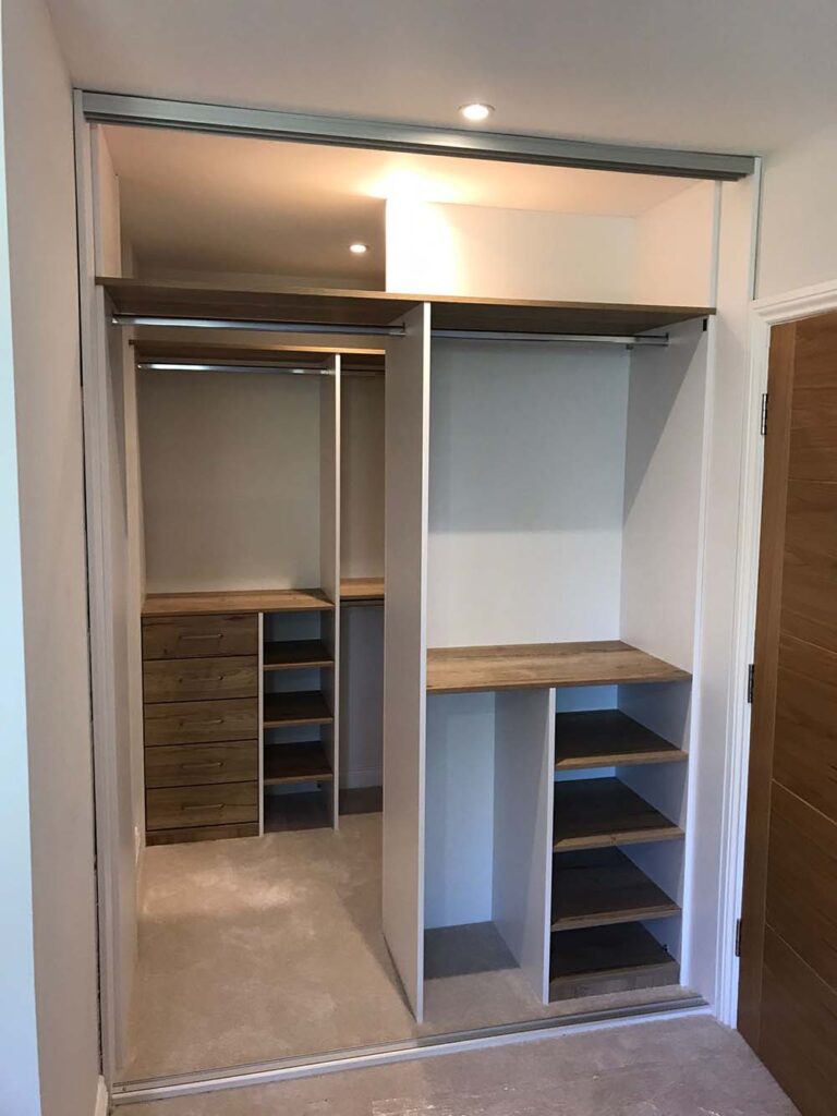 interior of sliding wardrobe with woodgrain finish