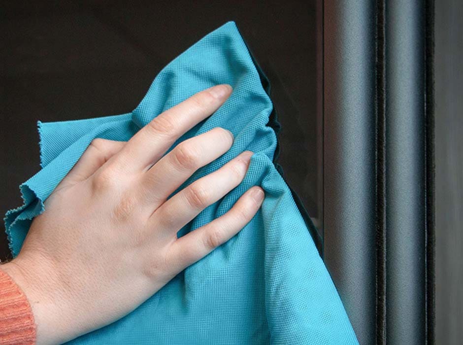 close up of someones hand wiping wardrobe mirror